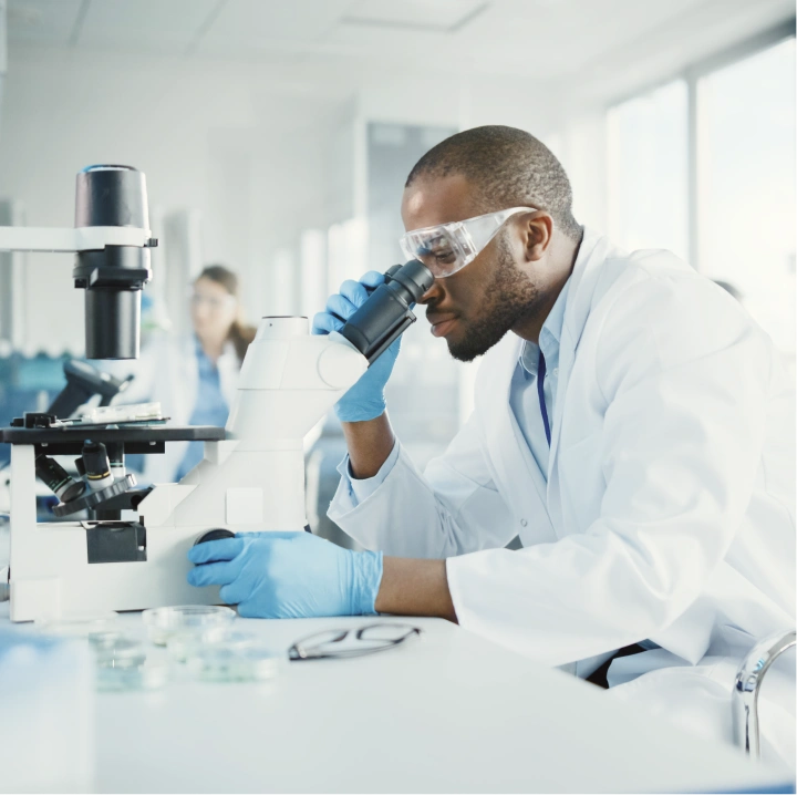 Doctor analyzing sample under microscope